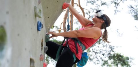 A person is climbing on a climbing wall.