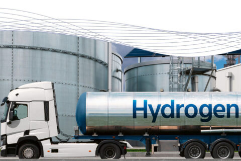 A large truck with a trailer on which hydrogen is written.