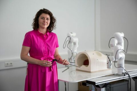 Professor Mathis-Ulrich, standing in front of a table.